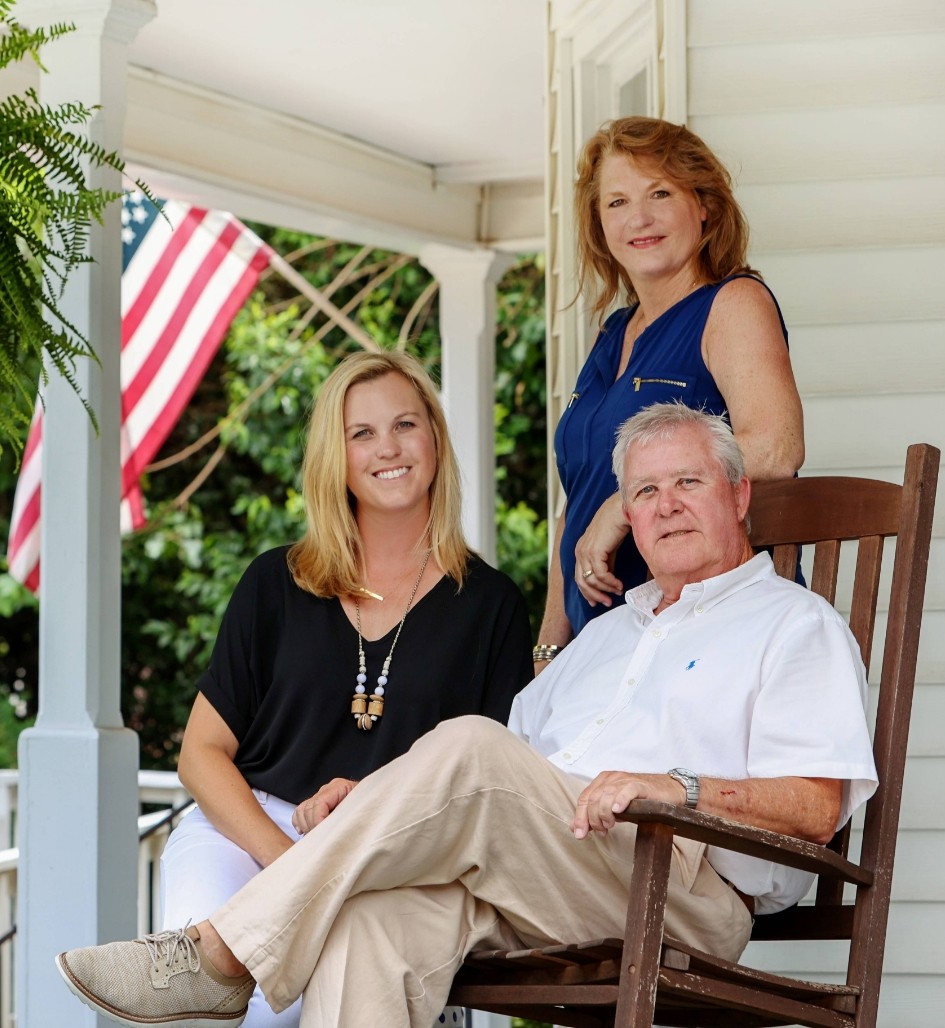 part of the Front Runner Realty team sitting on a porch